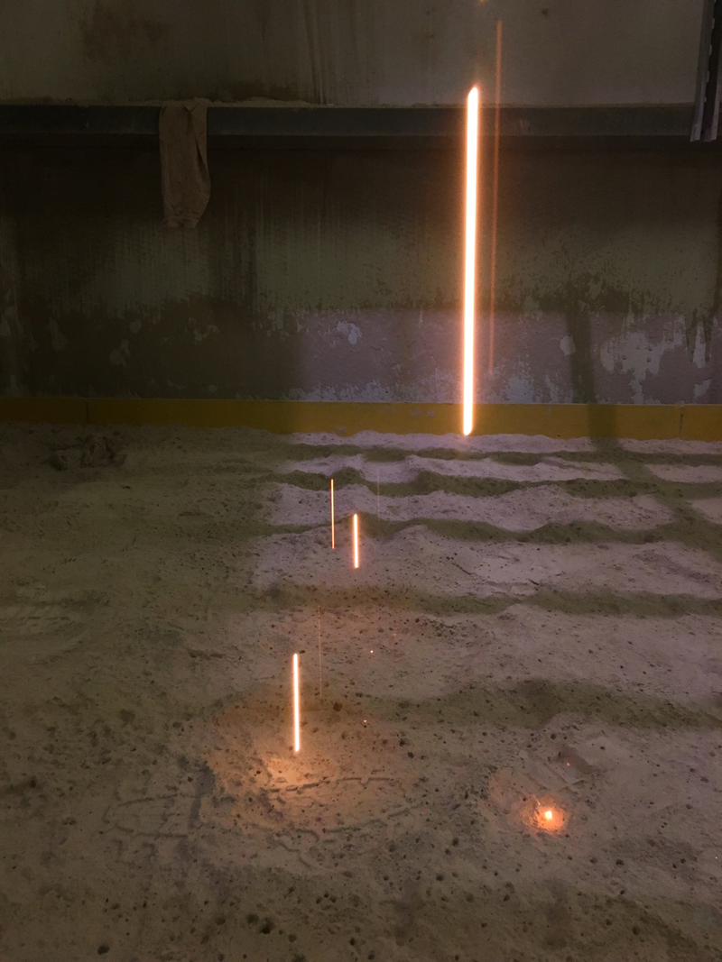 Weld spatter falling from the floor above into a powdered limestone filler mess.